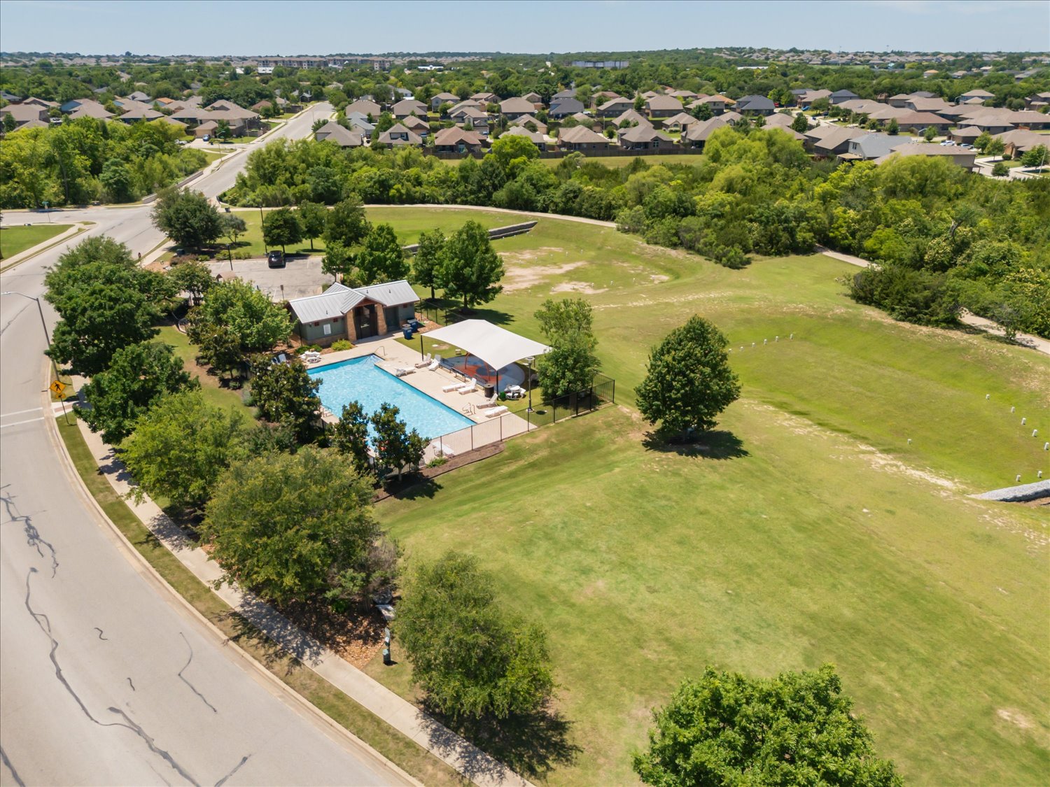717 Kaluga Trail Leander, TX 78641 - Photo 39 of 40 an aerial view of lake residential houses with outdoor space and swimming pool