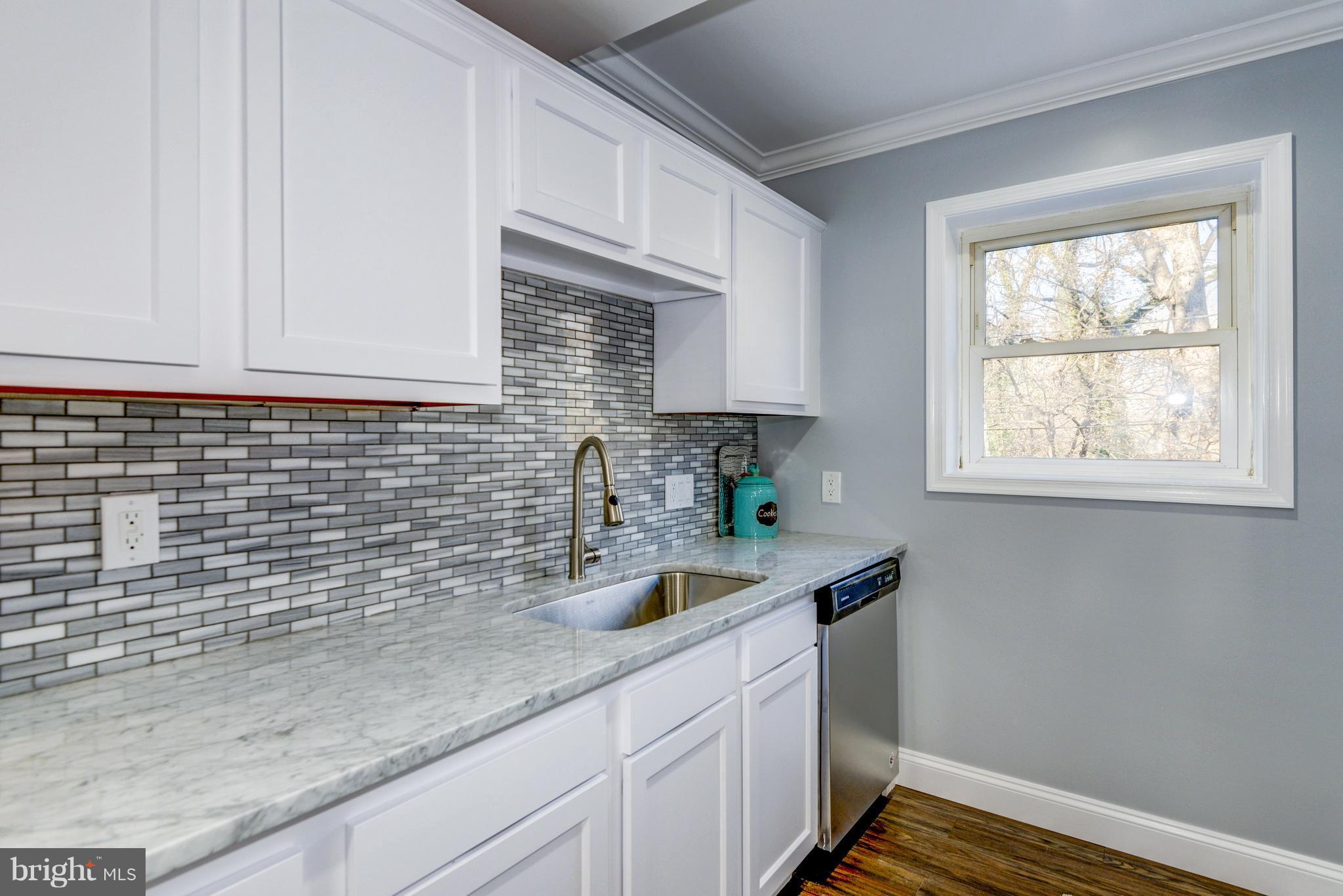 4622 Rokeby Road Baltimore, MD 21229 - Photo 11 of 27 a kitchen with sink cabinets and window
