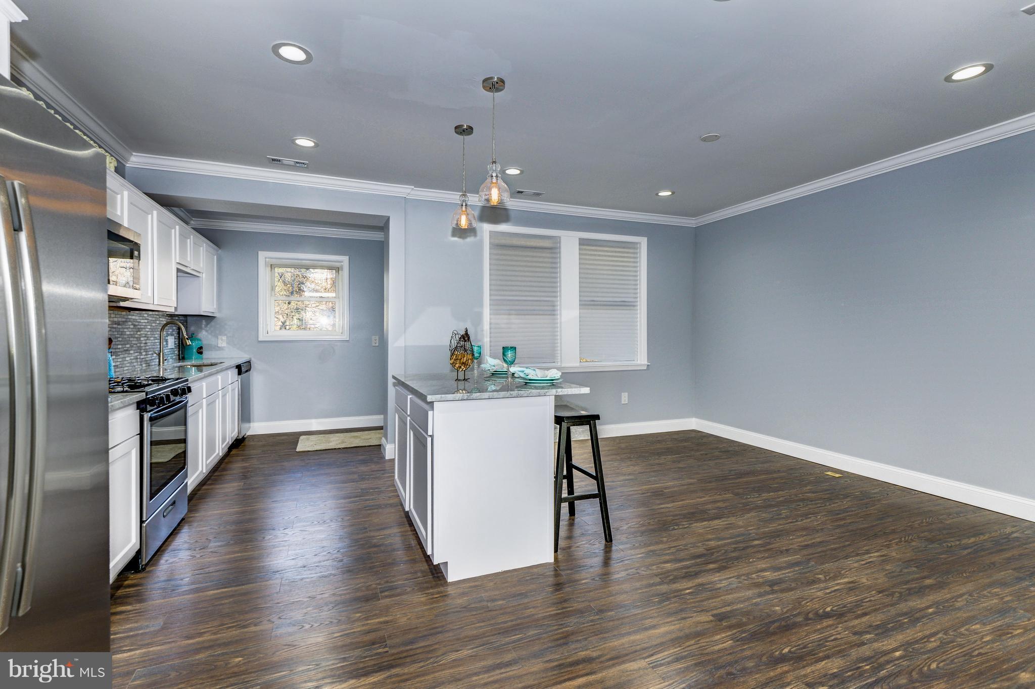 4622 Rokeby Road Baltimore, MD 21229 - Photo 13 of 27 a kitchen with wooden floors and refrigerator