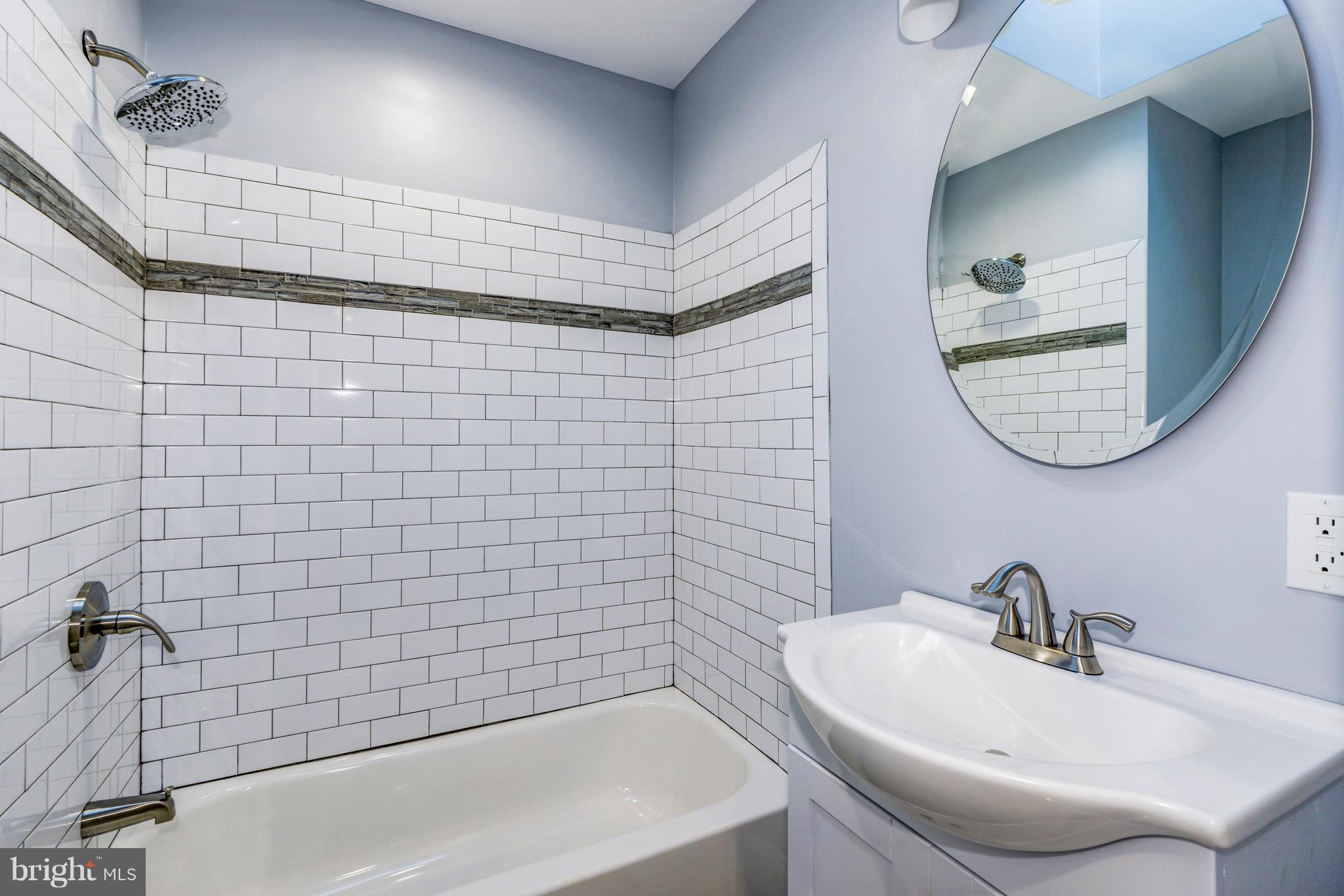 4622 Rokeby Road Baltimore, MD 21229 - Photo 17 of 27 a bathroom with a sink a toilet and a mirror