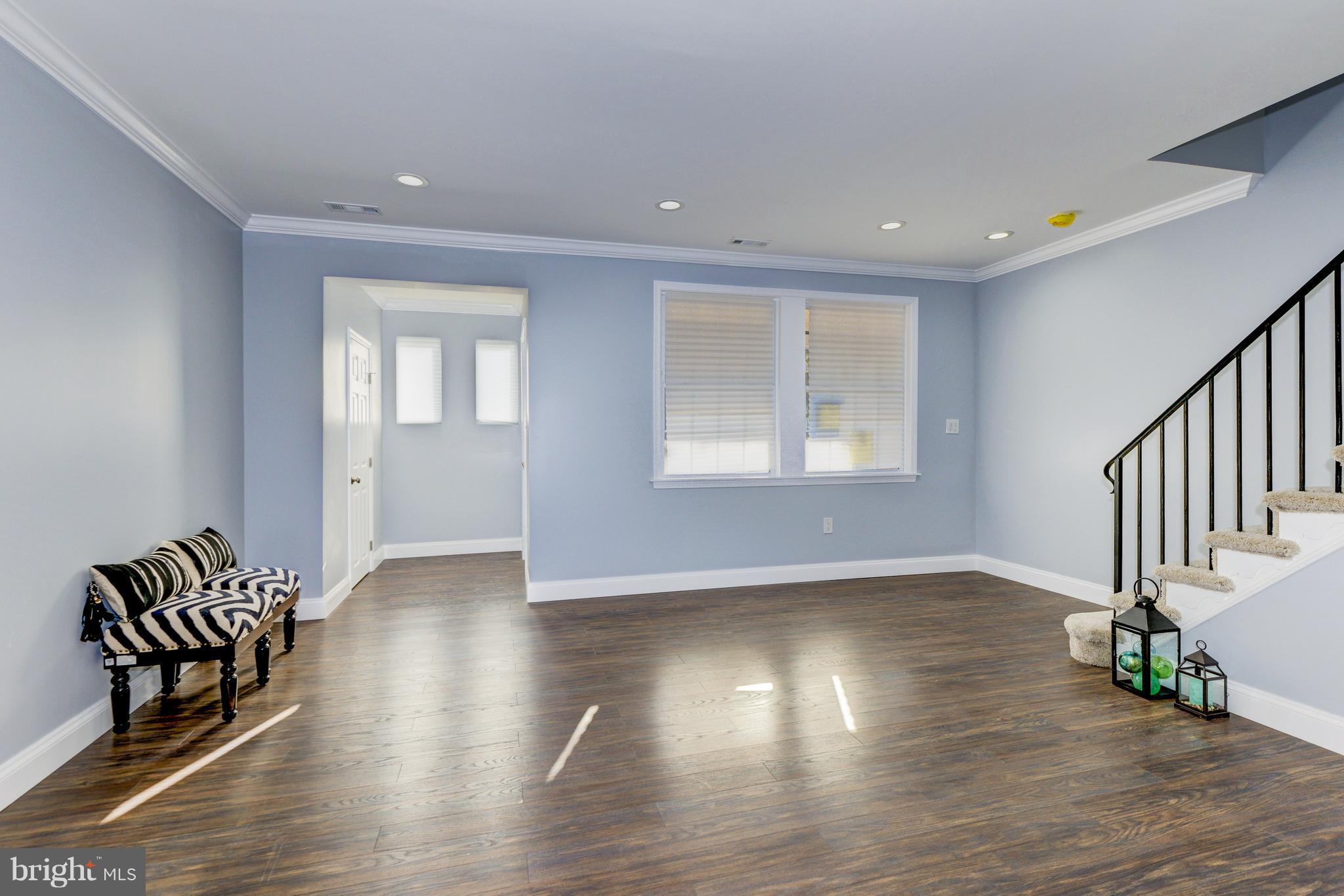 4622 Rokeby Road Baltimore, MD 21229 - Photo 4 of 27 a view of an empty room with wooden floor and a window