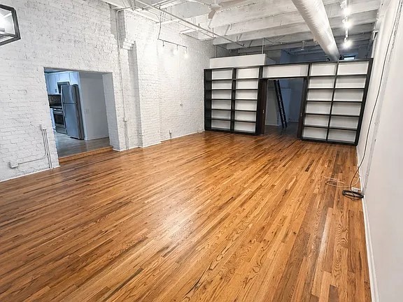 312 North May Street, Unit 4H Chicago, IL 60607 - Photo 2 of 13 a view of empty room with wooden floor and windows
