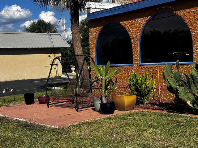 a view of swimming pool with chairs and wooden fence