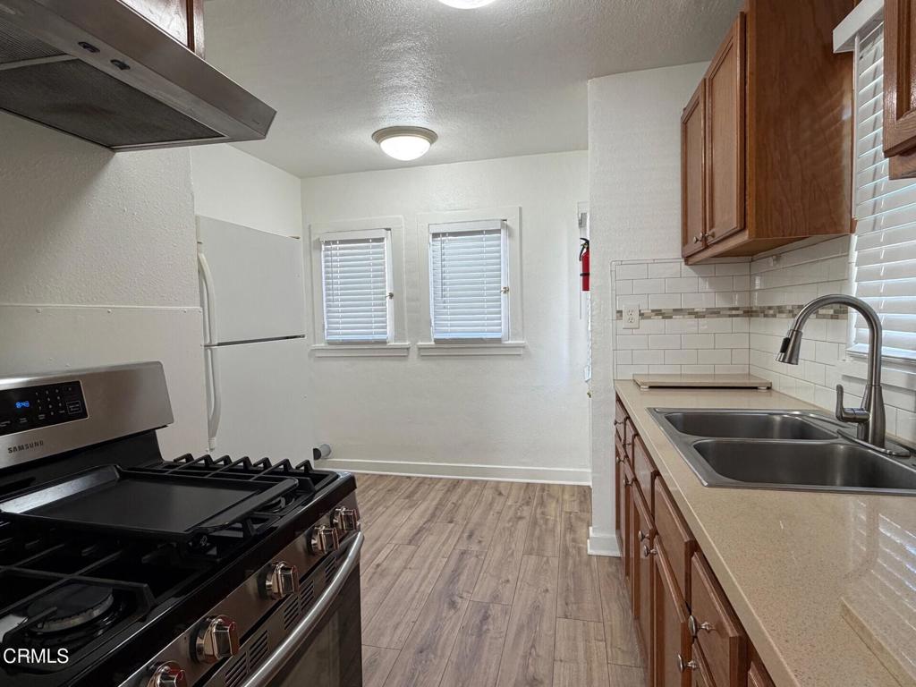 1107 East Howard Street Pasadena, CA 91104 - Photo 5 of 14 a kitchen with granite countertop a stove and a sink