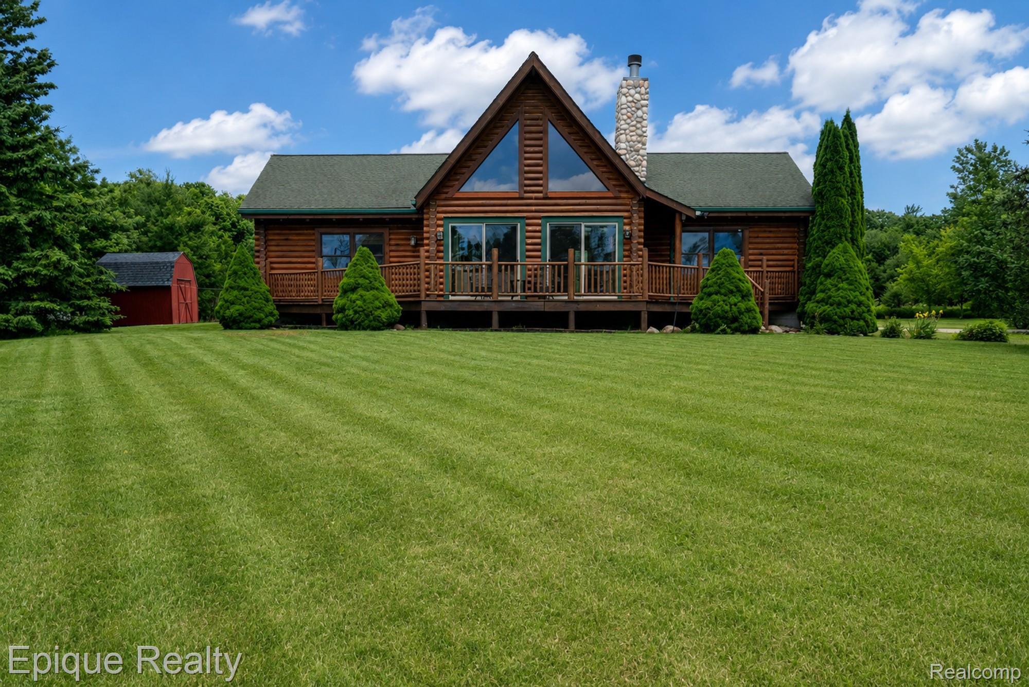 1966 Mayer Road Smiths Creek, MI 48074 - Photo 1 of 38 Log cabin exterior with a prominent stone chimney and A-frame window design
