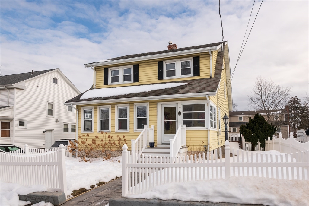 front view of a house with a fence