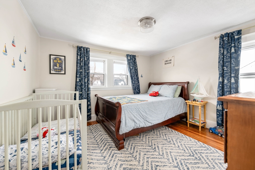 40 Virginia Road Quincy, MA 02169 - Photo 15 of 29 a bedroom with a bed and a window