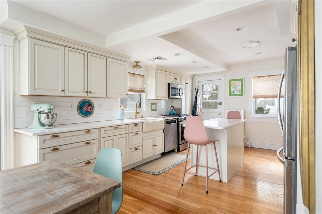 40 Virginia Road Quincy, MA 02169 - Photo 5 of 29 a kitchen with a sink cabinets and wooden floor