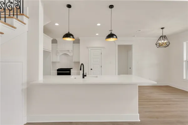 a view of a kitchen with a sink a refrigerator and window
