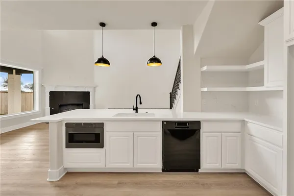a kitchen with a sink and white cabinets