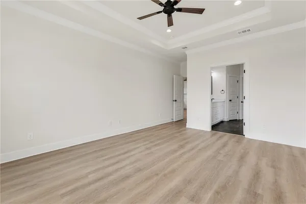 an empty room with fan and a ceiling fan