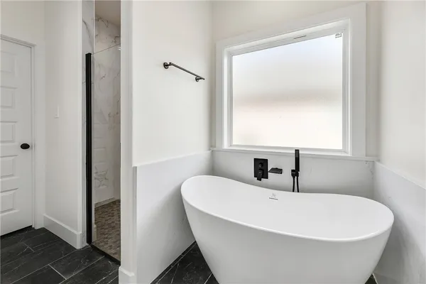 a white bath tub sitting next to a white sink