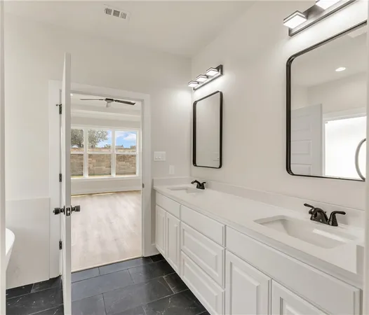 a bathroom with a double vanity sink mirror and