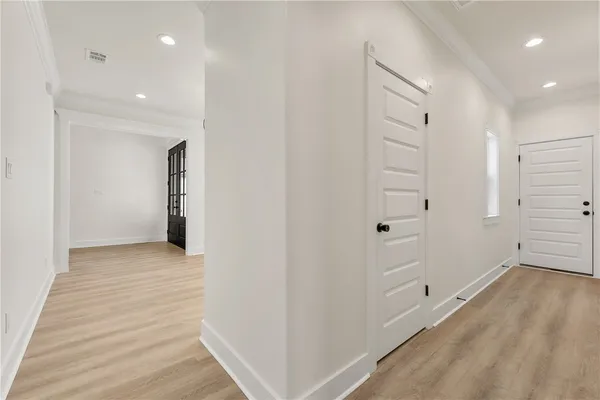 a view of a hallway with wooden floor