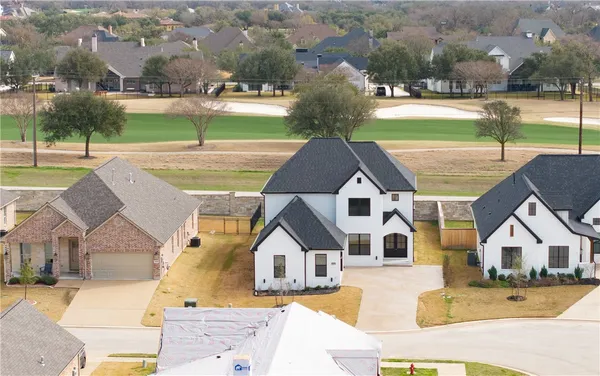 an aerial view of a house with a big yard
