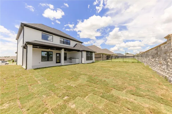 a front view of a house with a big yard and chandelier