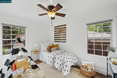 a bedroom with furniture and a large window