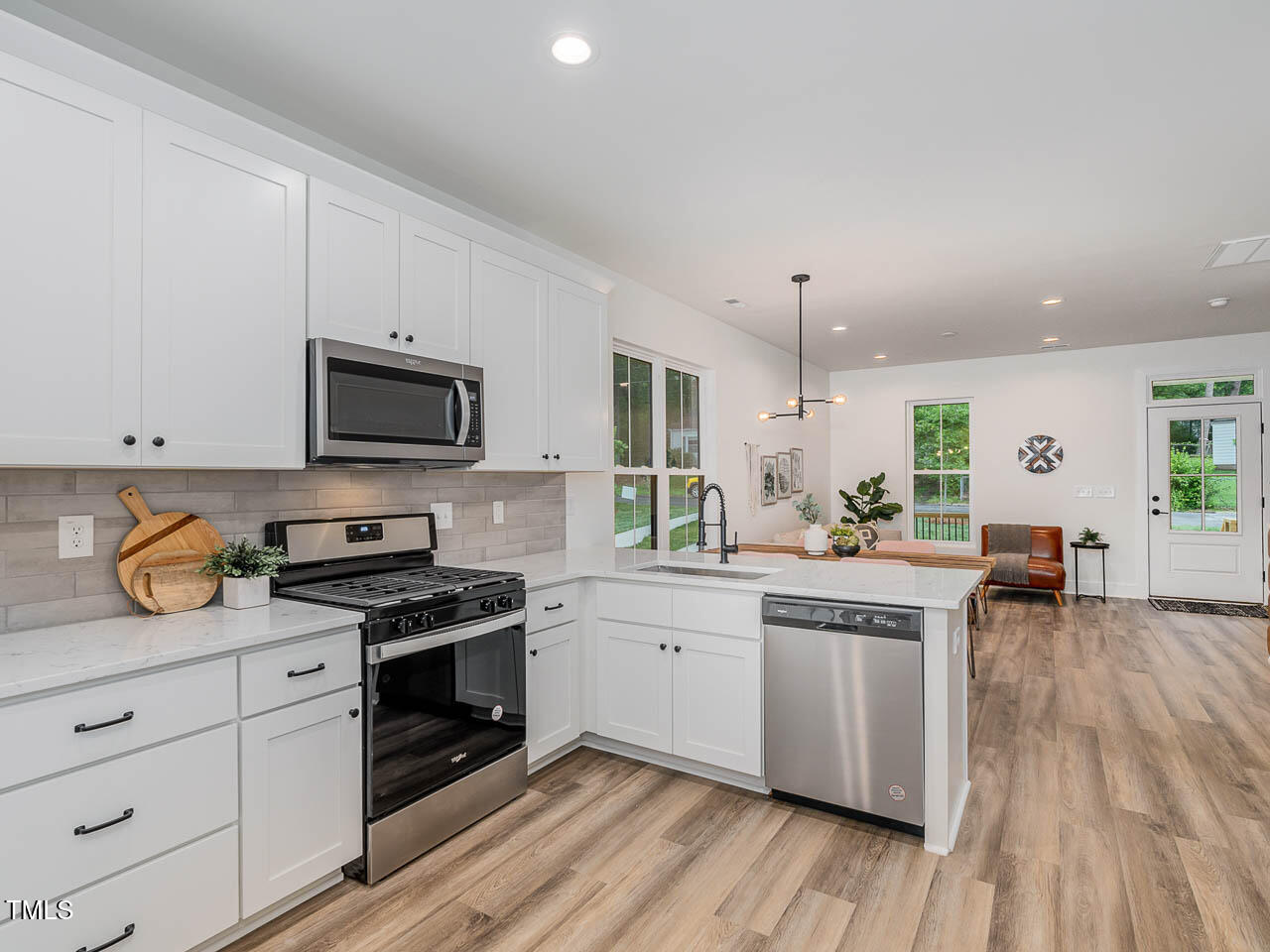 614 East Ellerbee Street Durham, NC 27704 - Photo 6 of 12 a kitchen with stainless steel appliances granite countertop a stove and a wooden floors