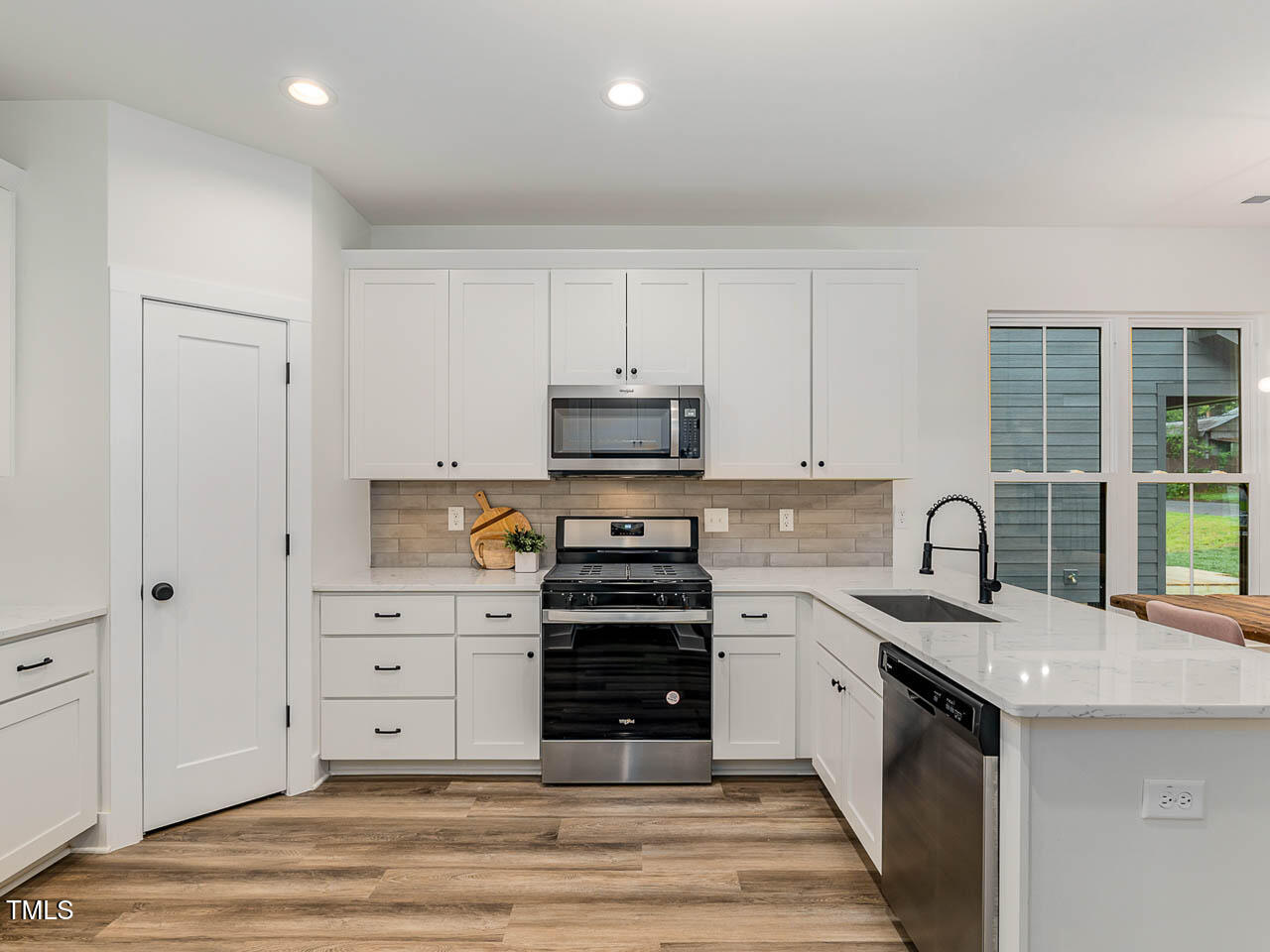 614 East Ellerbee Street Durham, NC 27704 - Photo 7 of 12 a kitchen with stainless steel appliances a stove sink and cabinets