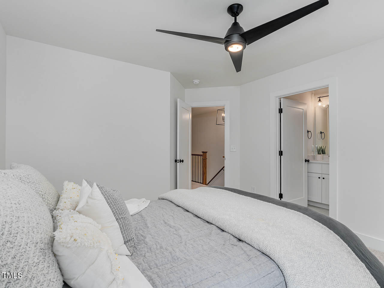 614 East Ellerbee Street Durham, NC 27704 - Photo 9 of 12 a bedroom with a bed and a ceiling fan