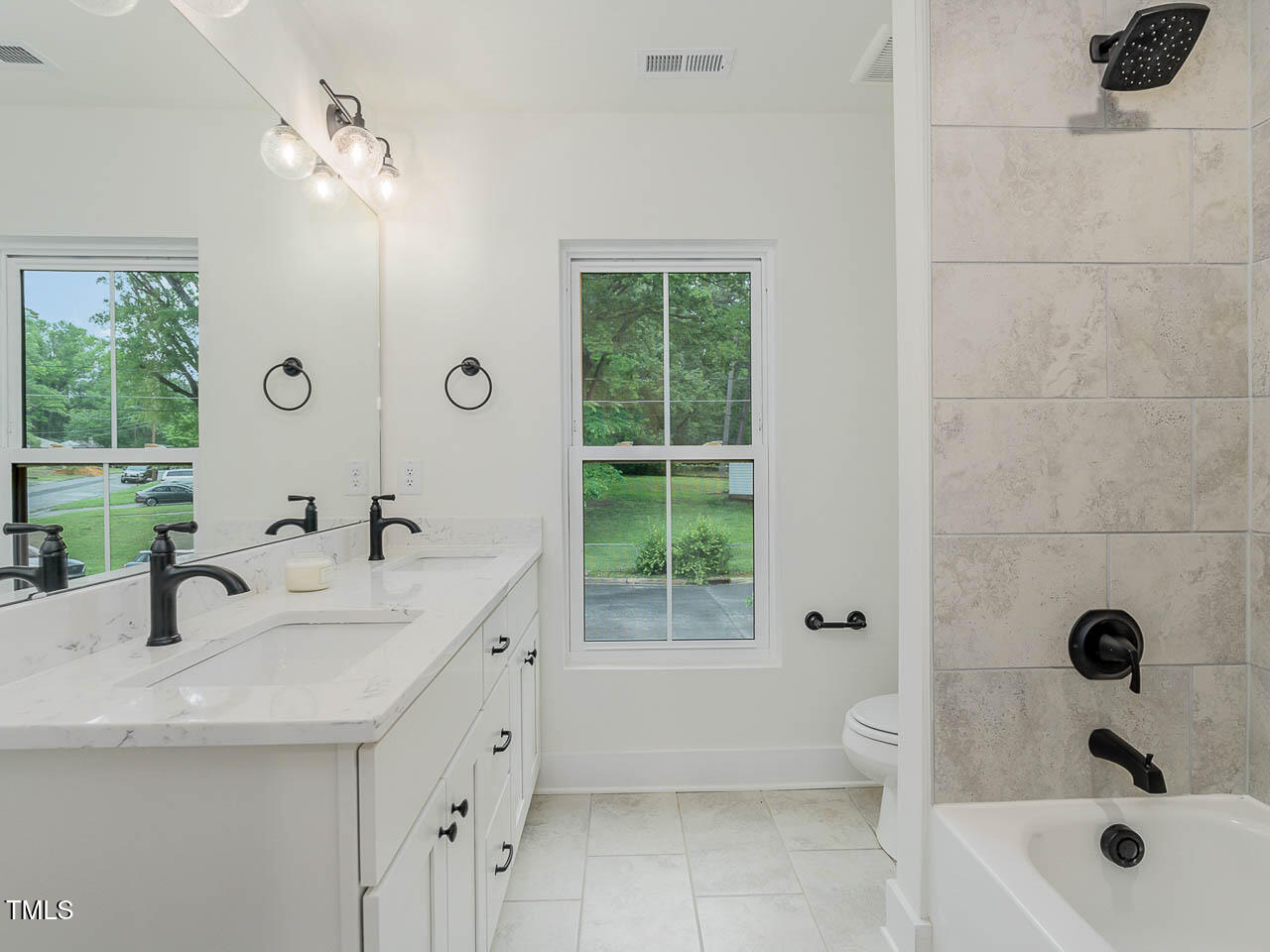 614 East Ellerbee Street Durham, NC 27704 - Photo 10 of 12 a bathroom with a tub a sink and mirror