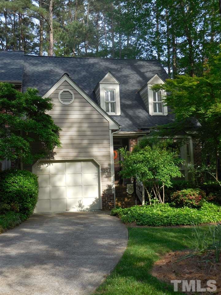 1307 Slatestone Court Raleigh, NC 27615 - Photo 2 of 25 a front view of a house with a yard and garage