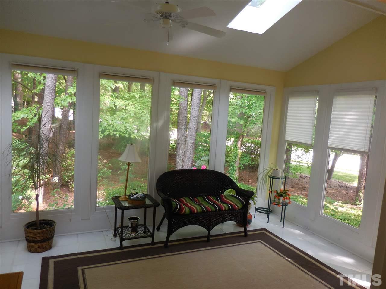 1307 Slatestone Court Raleigh, NC 27615 - Photo 11 of 25 a living room with a large window and floor to ceiling window