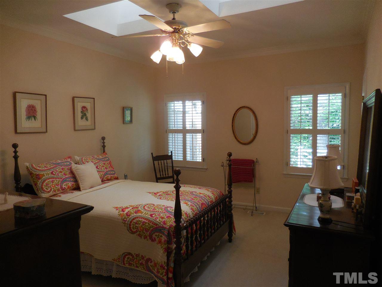 1307 Slatestone Court Raleigh, NC 27615 - Photo 13 of 25 a bedroom with a bed window chandelier and a window