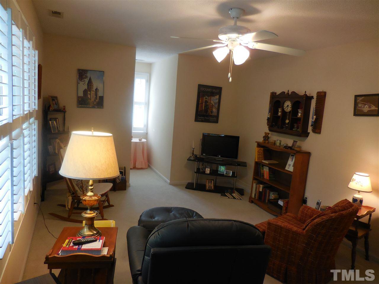 1307 Slatestone Court Raleigh, NC 27615 - Photo 16 of 25 a bedroom with bed and a chandelier