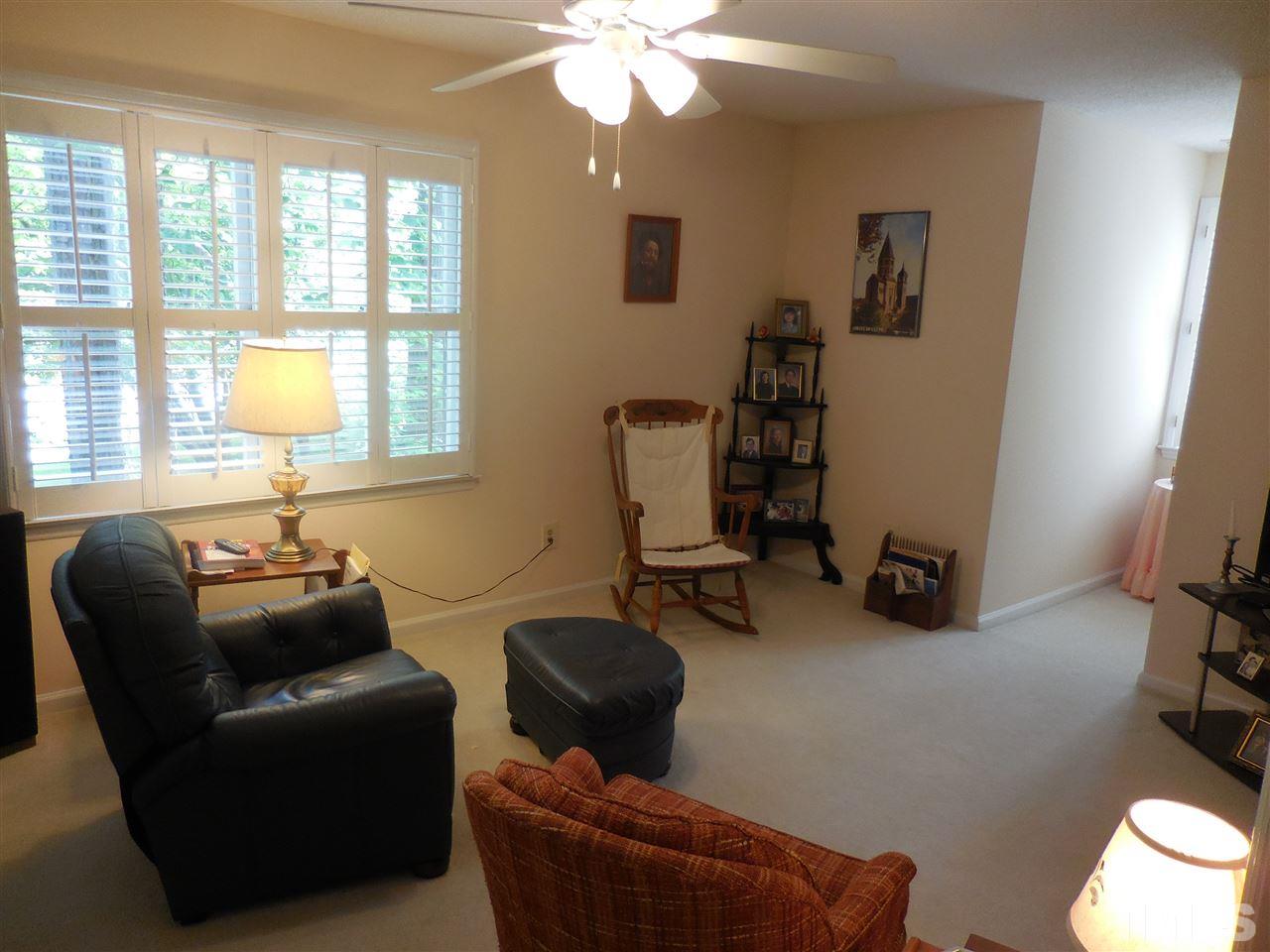 1307 Slatestone Court Raleigh, NC 27615 - Photo 17 of 25 a livingroom with workspace window and a couch