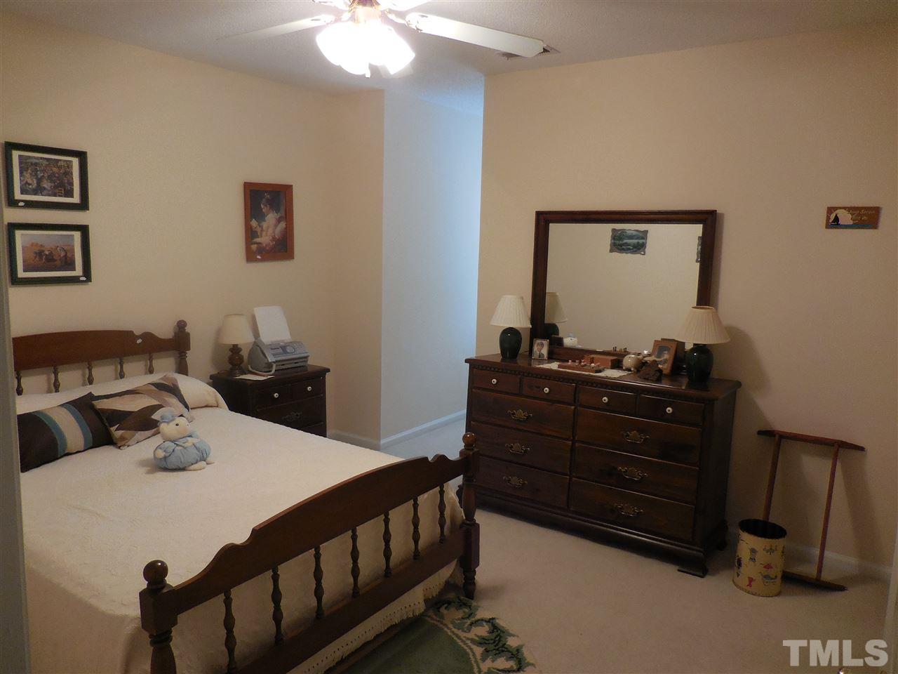 1307 Slatestone Court Raleigh, NC 27615 - Photo 18 of 25 a bedroom with a bed and a dresser