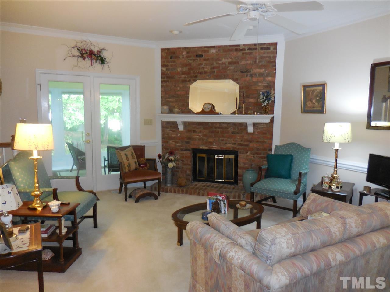 1307 Slatestone Court Raleigh, NC 27615 - Photo 9 of 25 a living room with furniture and a fireplace