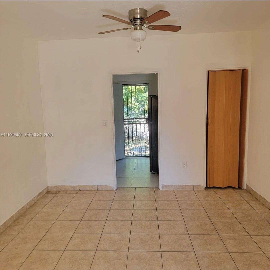 63 Northwest 68th Terrace, Unit 63 Miami, FL 33150 - Photo 2 of 5 a view of an empty room with a window