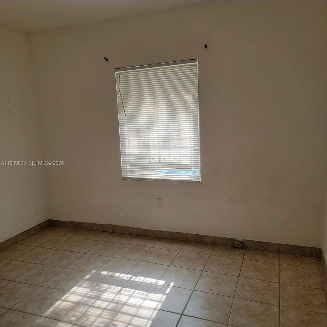 63 Northwest 68th Terrace, Unit 63 Miami, FL 33150 - Photo 3 of 5 a view of an empty room with a window