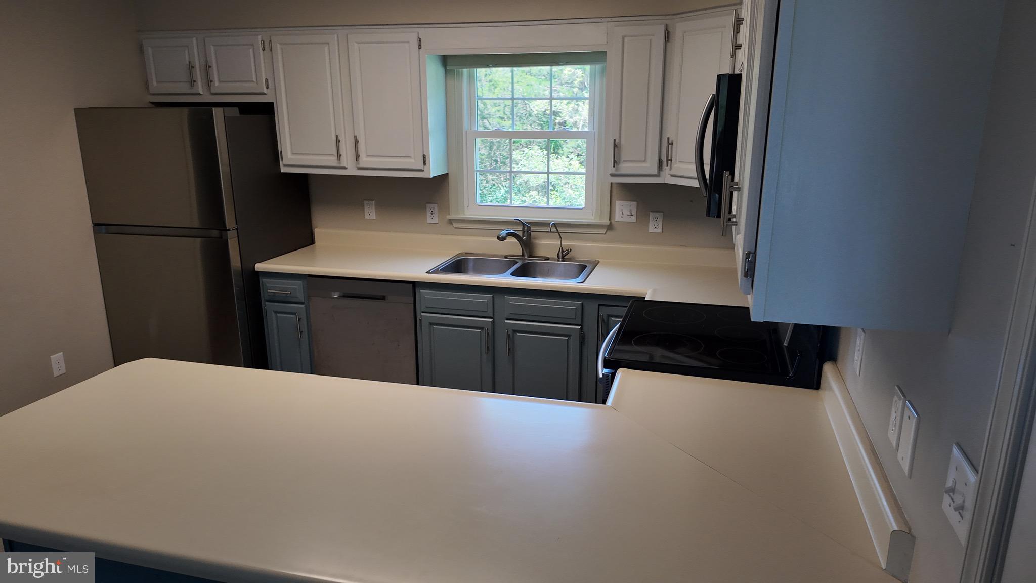 1185 Kesler Road Front Royal, VA 22630 - Photo 19 of 51 a kitchen with stainless steel appliances a refrigerator sink and cabinets