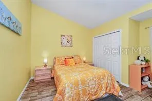 a bedroom with a bed and a painting on the wall
