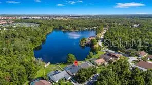 an aerial view of residential houses with outdoor space and river