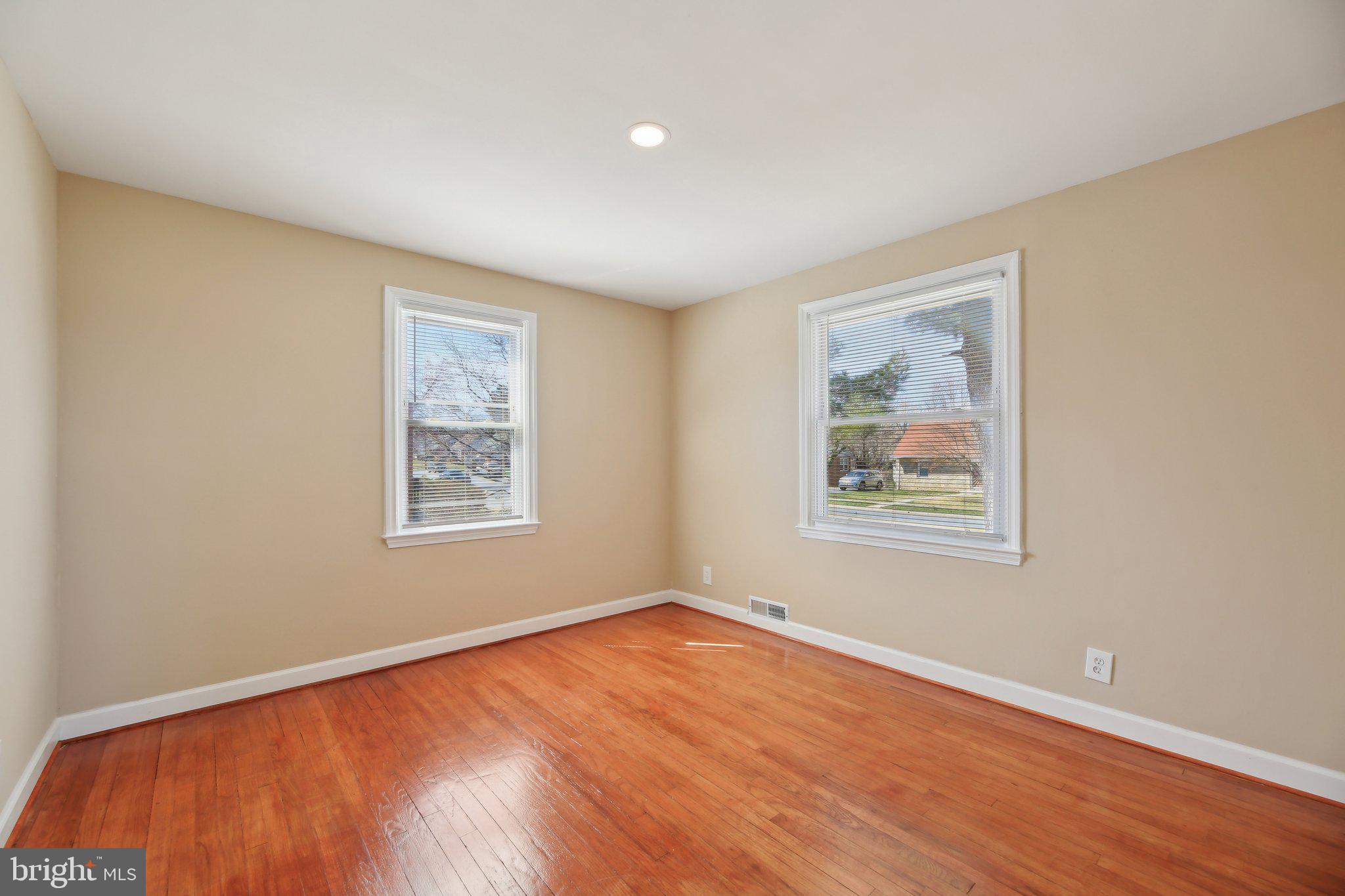 3547 Milford Mill Road Baltimore, MD 21244 - Photo 14 of 44 a view of an empty room with window and wooden floor
