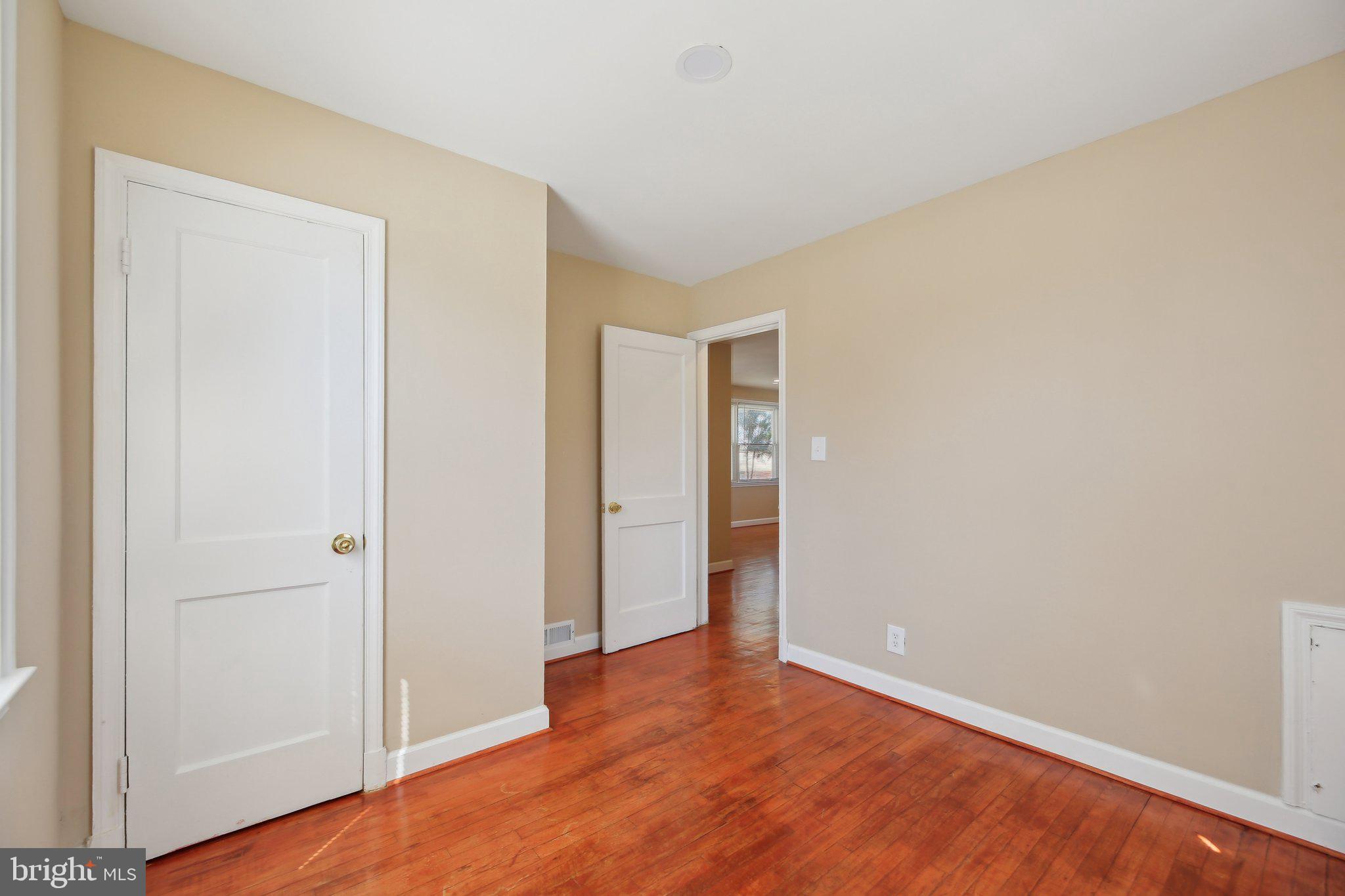 3547 Milford Mill Road Baltimore, MD 21244 - Photo 17 of 44 a view of an empty room with wooden floor and closet