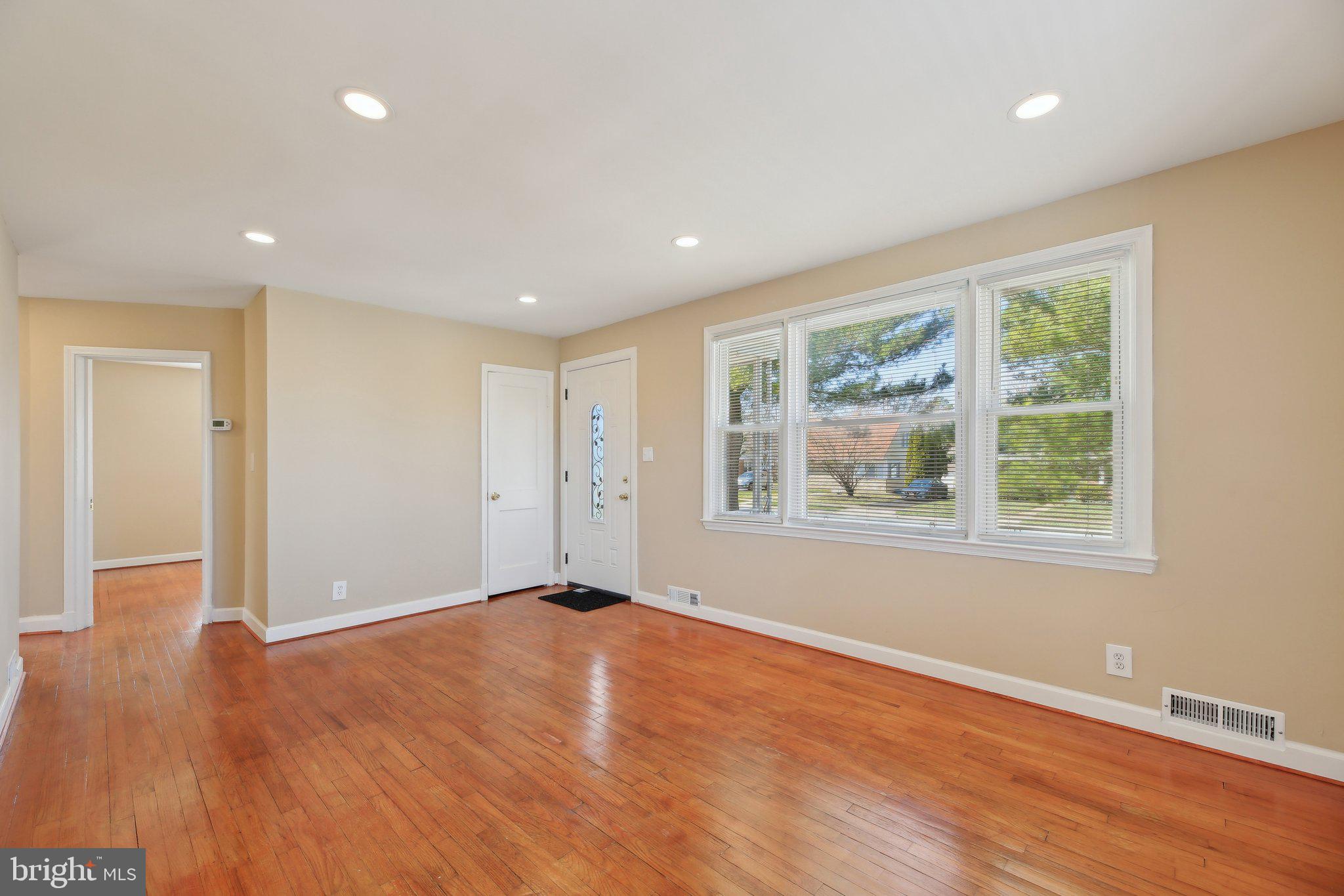 3547 Milford Mill Road Baltimore, MD 21244 - Photo 3 of 44 a view of an empty room with wooden floor and a window
