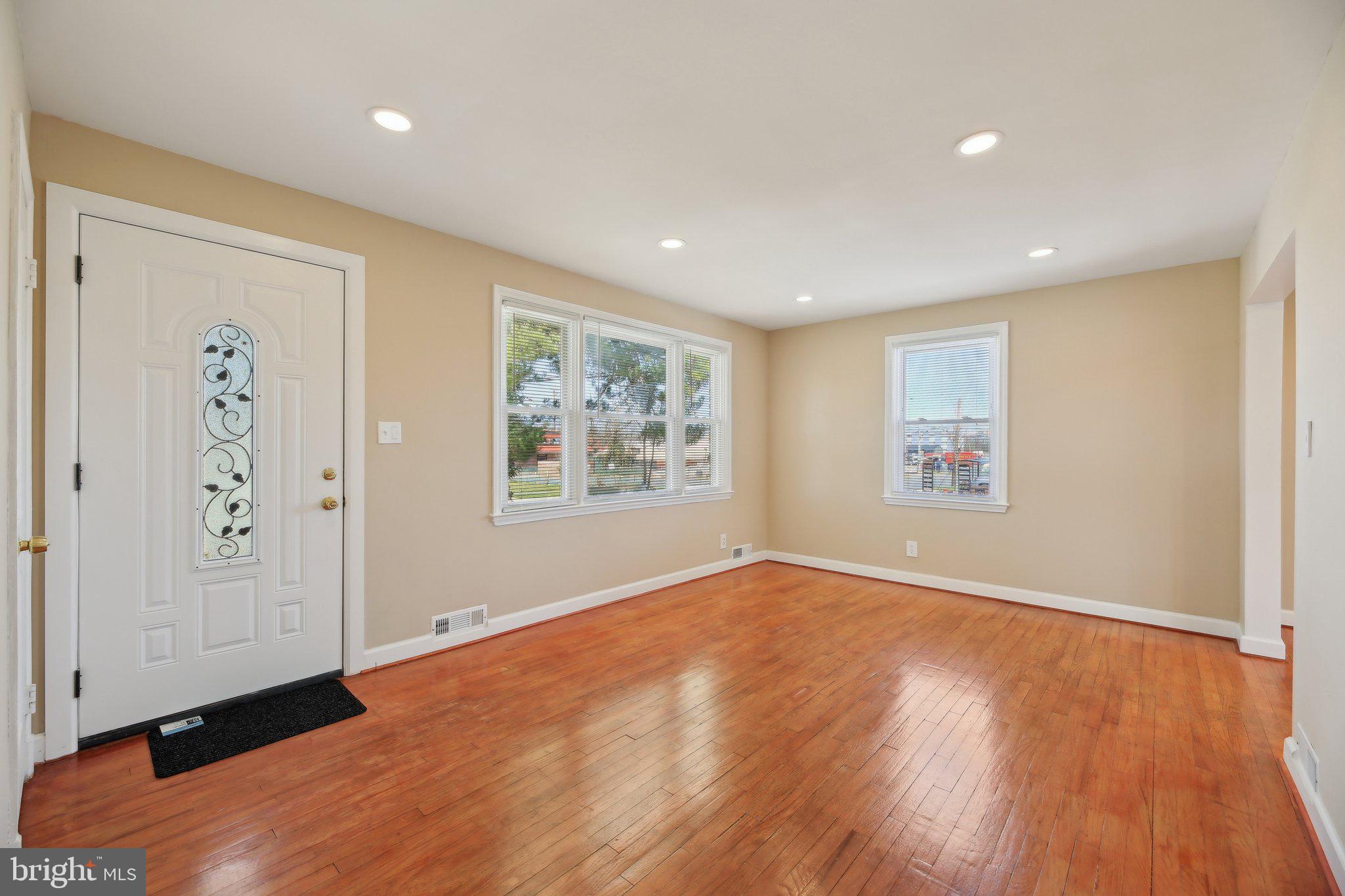 3547 Milford Mill Road Baltimore, MD 21244 - Photo 4 of 44 an empty room with wooden floor and windows