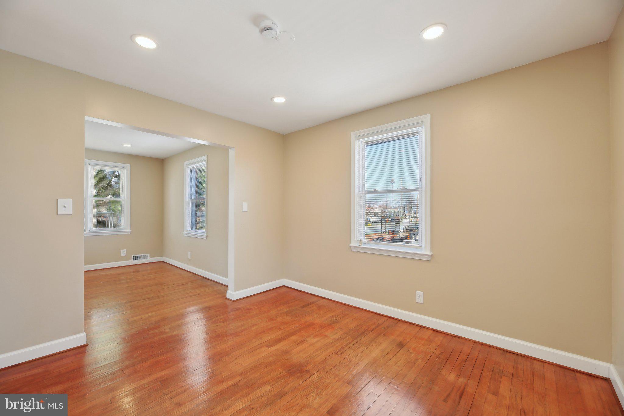 3547 Milford Mill Road Baltimore, MD 21244 - Photo 8 of 44 an empty room with wooden floor and windows