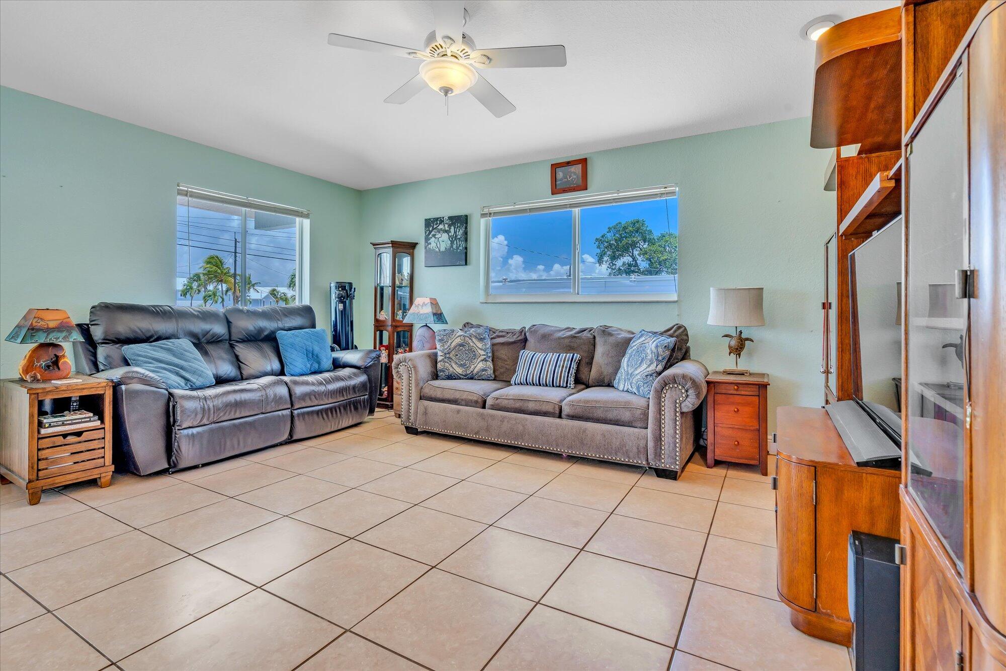 939 Plantation Road Key Largo, FL 33037 - Photo 11 of 38 a living room with furniture and a flat screen tv