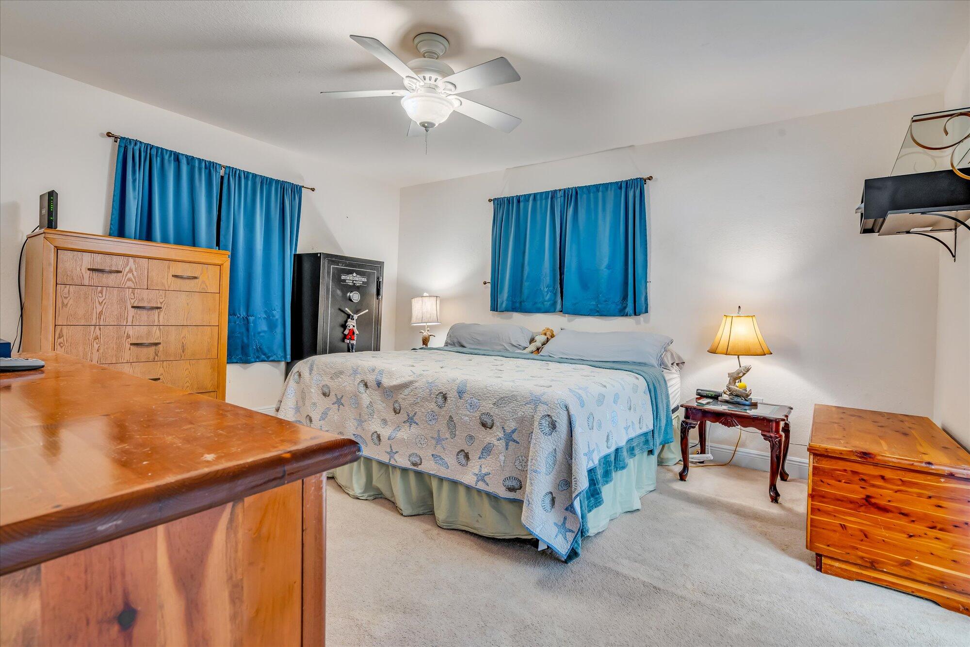 939 Plantation Road Key Largo, FL 33037 - Photo 13 of 38 a spacious bedroom with a bed and a lamp