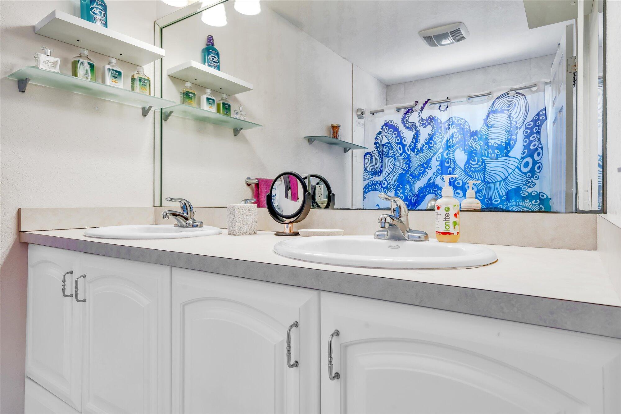 939 Plantation Road Key Largo, FL 33037 - Photo 15 of 38 a bathroom with a sink and a mirror