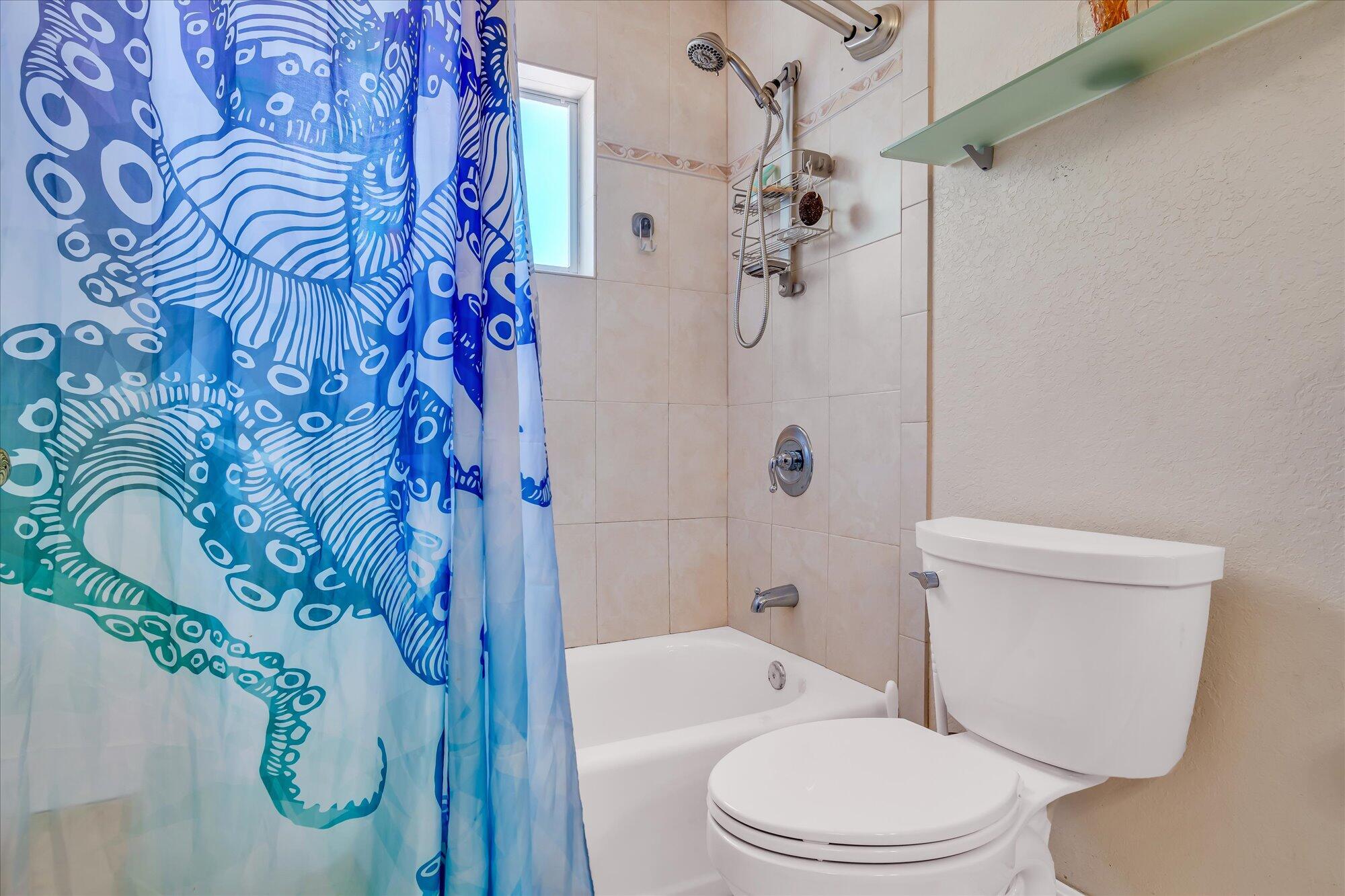 939 Plantation Road Key Largo, FL 33037 - Photo 16 of 38 a white toilet sitting next to a bath tub