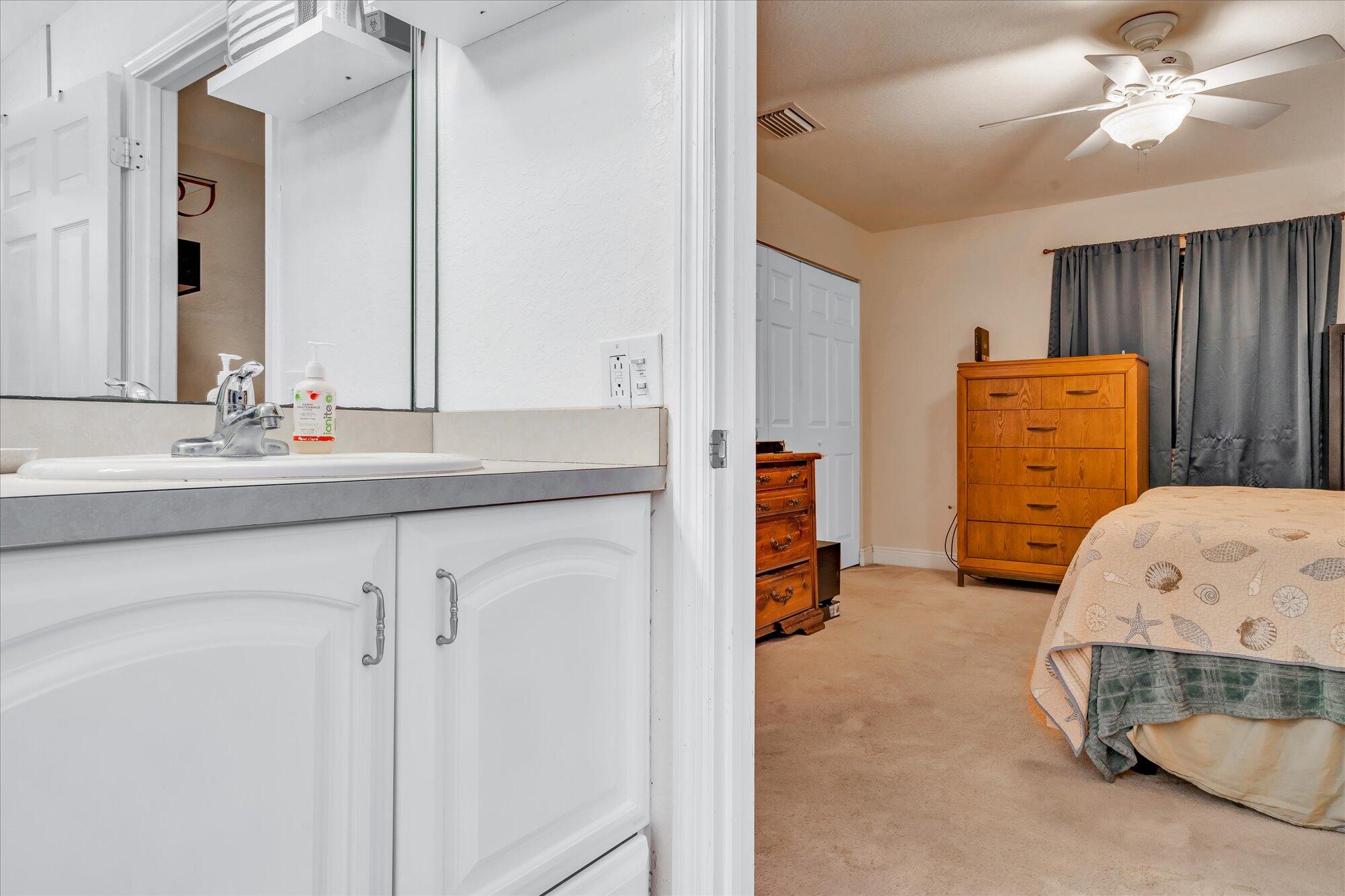 939 Plantation Road Key Largo, FL 33037 - Photo 17 of 38 a en suite bathroom with a double vanity sink and mirror