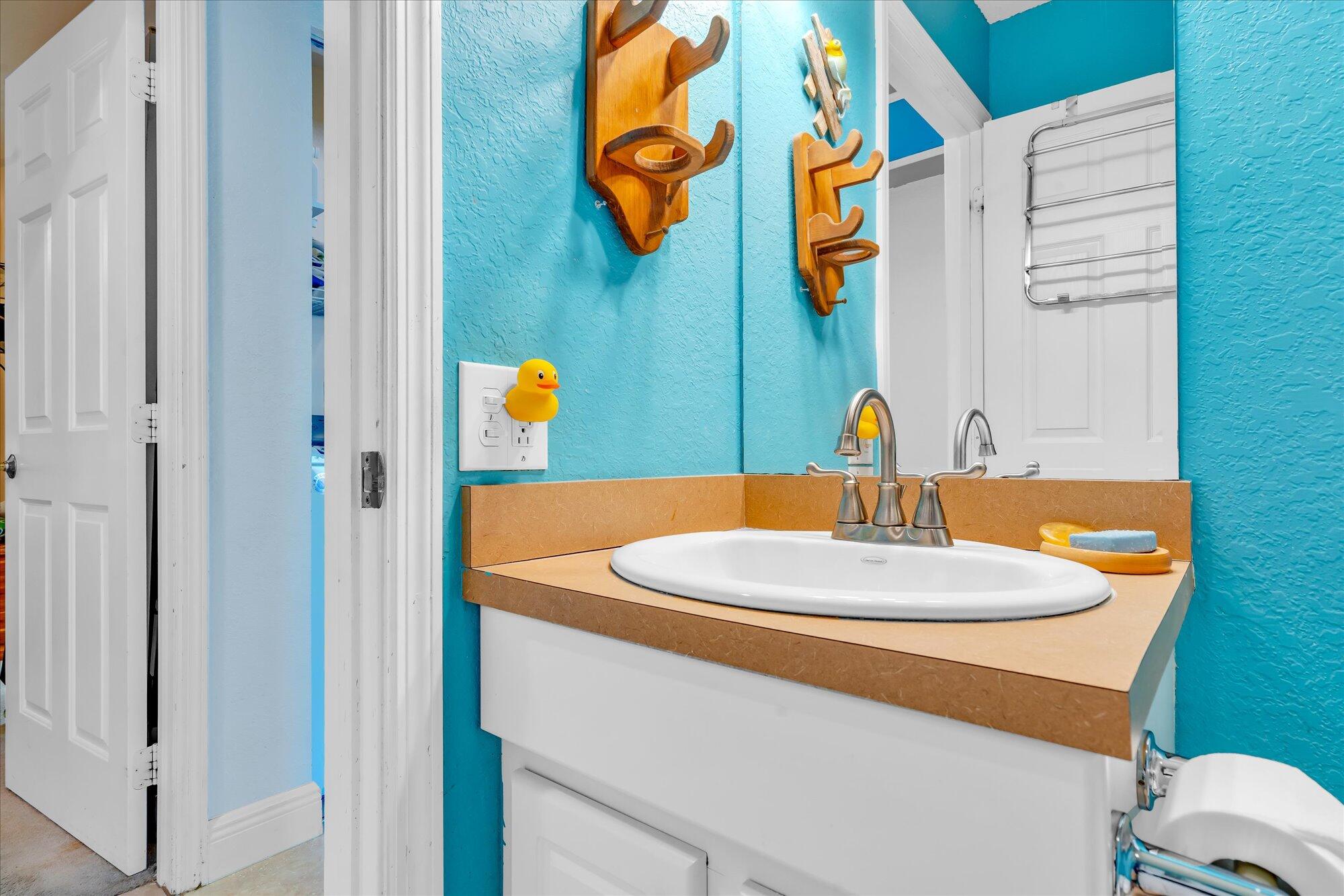 939 Plantation Road Key Largo, FL 33037 - Photo 23 of 38 a bathroom with a sink and a mirror