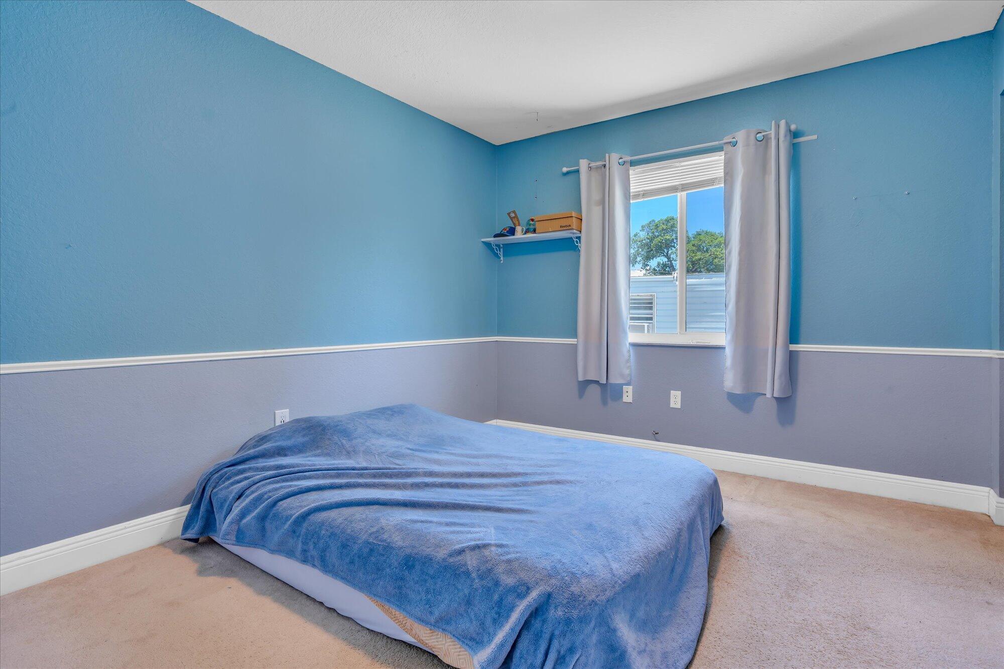 939 Plantation Road Key Largo, FL 33037 - Photo 25 of 38 a bedroom with a bed and a window
