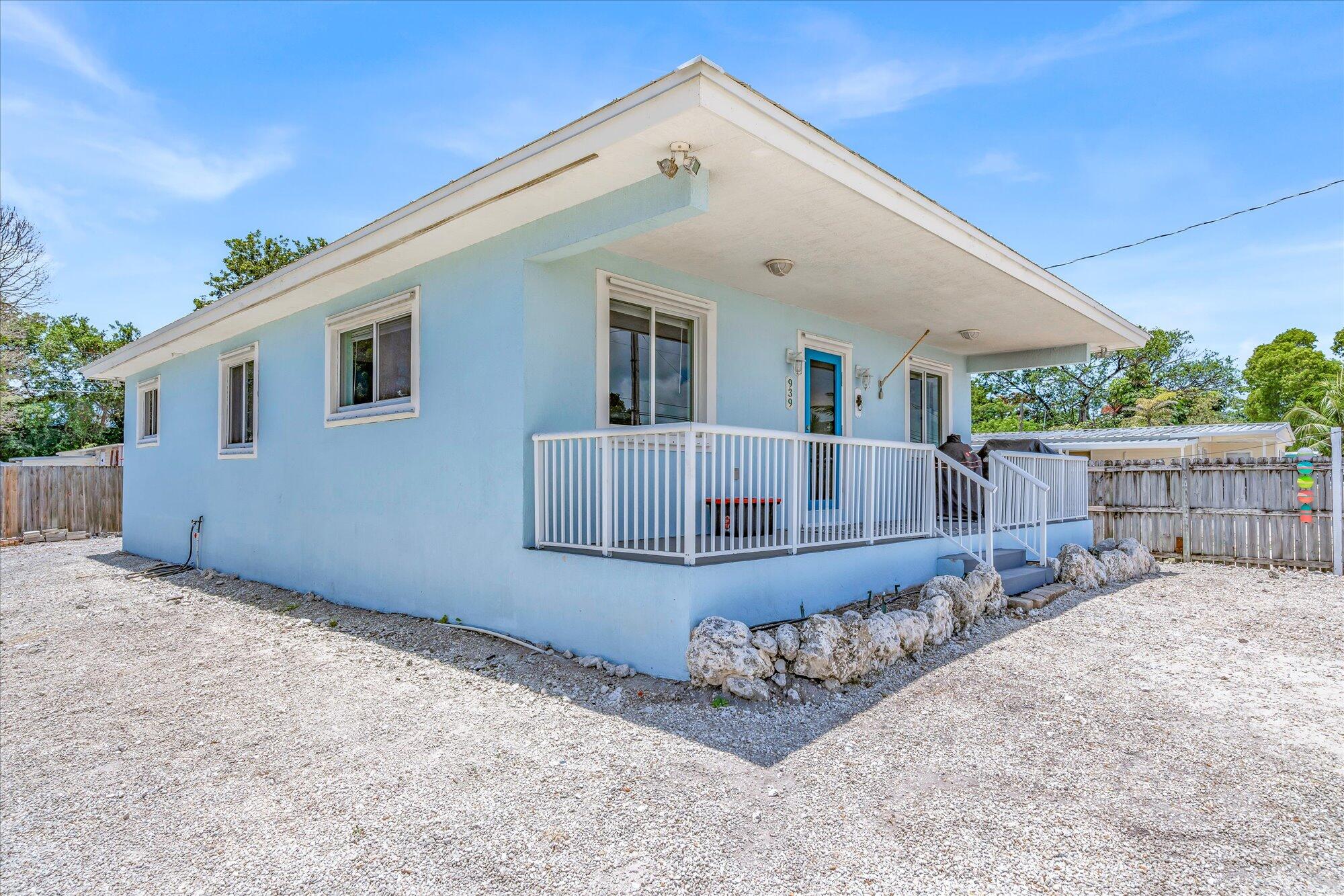 939 Plantation Road Key Largo, FL 33037 - Photo 27 of 38 a view of a house with a patio and a yard